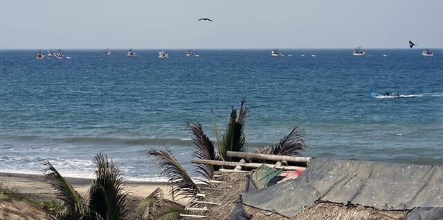 Slow travel discovers large fishing barcos off shore
